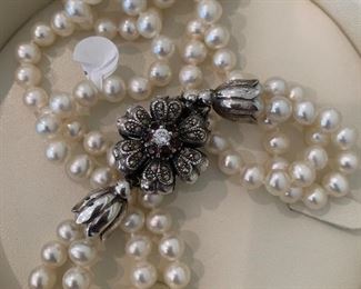 Lustrous pearls with a sterling silver and marcasite blossom clasp.