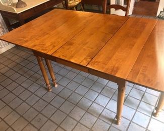 Maple dining room table with leaves on both sides that fold in allowing for very good size / dining options..