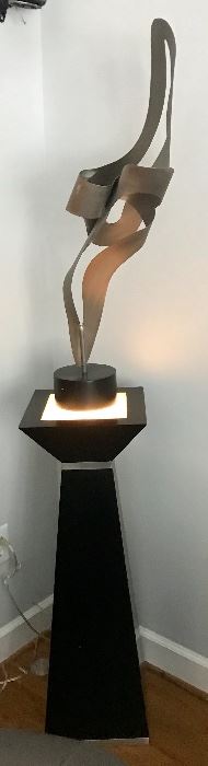 Sculpture on lighted pedestal