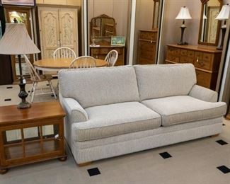 This cream & black sofa looks new!  The end table opens and is lighted - a great piece.