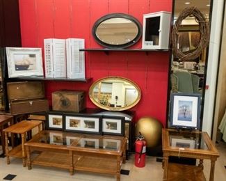 Lots of occasional tables, art, mirrors, and wooden boxes.  On the far left are three stack able tables.