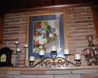 Ornate frame with picture and metal candleholders, mantel clock
