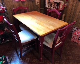 nice size wooden table with red legs; 4 chairs
