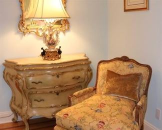 Custom upholstered lounge chair, pair of antique Italian giltwood and gesso marble-topped bombe commode(s)), gilt rococo mirror