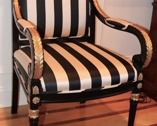 Custom upholstered, ebonized and carved gilt dining chairs