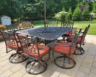 Wrought Iron Table wit Lazy Susan with Eight swivel chairs with cushions  60" W x 60" D x 29" T