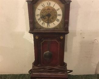 Miniture clock has a nick on one of the corners ,works well