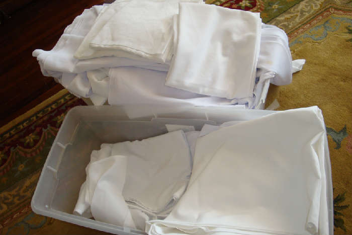White commercial tablecloths, round or square.