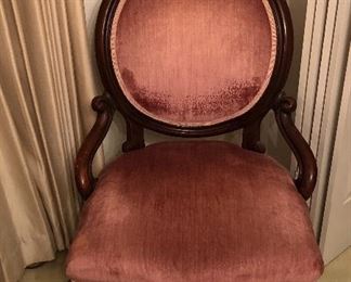 Beautiful antique Victorian parlor chair. Carved floral detail on crest and legs. Rose red velvet upholstery in beautiful condition.