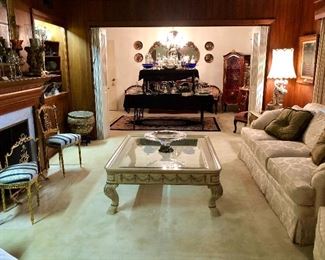 Dynamic centerpiece coffee table. 55” x 44”. Beveled glass. Detail carved and applied apron. Turned carved legs, hoof feet.