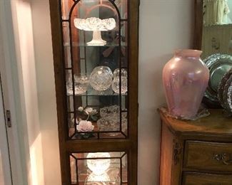  Walnut lighted display cabinet with applied molding and trim. Top and bottom light separately. 
24”x20”x72”