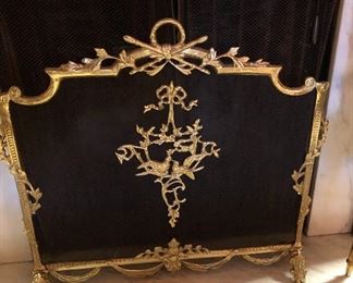 Louis the XVI style brass and mesh fireplace screen. Spiraling foliage & garland around centerpiece of lovebirds. Trestle feet. Circa 1960s