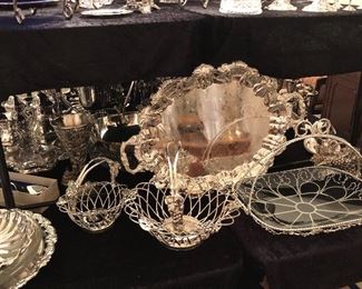 And array of silver plated items. Trays, bowls, serving pieces, water jugs, punch ladles, baskets, tiered serving pieces, goblets, casseroles, cake trays, more. 
