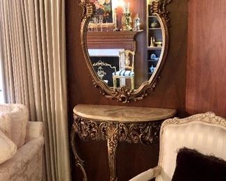 Rococo carved, gilt marble top console. Shaped mirror in carved gilt frame. 