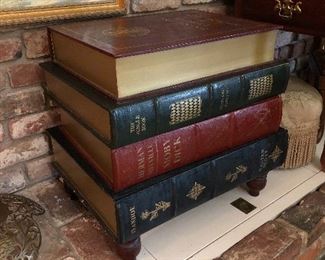 Stacked, gilded leather trompe l’oeil book table. This large stack of books offer storage in a lift top and two bottom drawers.