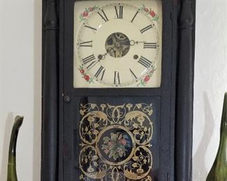 Many clocks throughout this luxury home. Black framed wooden clock.