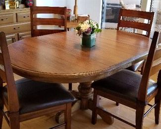 Solid wood oval kitchen/dining table and chairs.