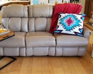 Neutral colored leather sofa. C table with drawer.