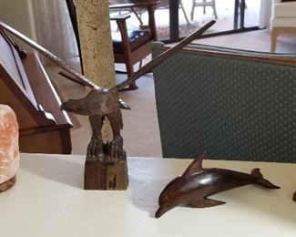 Wooden eagle and dolphins.