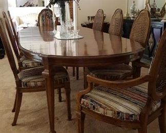 Gorgeous dining table with eight cane back chairs