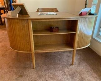 This Like New condition TOMLINSON desk #39 ==> pecan & butternut. Planked design end panels, open compartment on the reverse side for books or planter. Parwueted too. Six drawers, one for files. 55” W x 25” D x 30” H. 