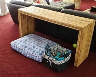 Sofa table and lots of dogs toys and bedding