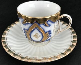Cobalt blue, cream and gold tea cup and saucer