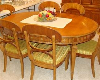 Table has three leaves and eight chairs