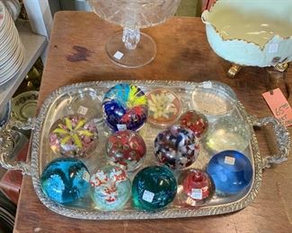 Paperweights rest on a silver plate tray, which is on top of a swivel table--come check out these items and more! Stagecoach Antiques is Offering 50% or more of ALL Inventory and Shelving units in the brick and mortar shop--July 26-28, 10-5 each day--see you in the shop!