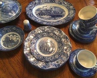 Assorted ironstone plates, cups with saucers, covered dish and platter in blue transferware , "Liberty Blue" of historical Colonial scenes, made in Staffordshire, England