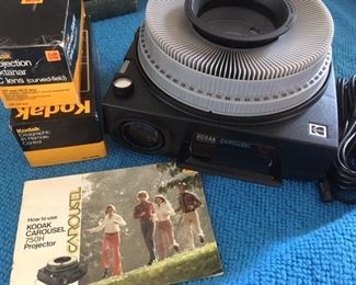 Kodak slide projector with accessories, folding screen and boxed carousels