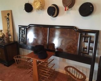 King size headboard in Asian-style, with pair of matching bedside cabinets; in foreground are various wood magazine racks