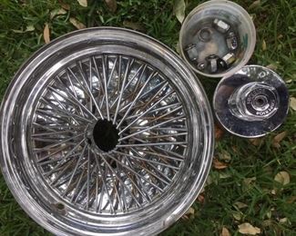 One of a set of four 15x7 chromed steel wire rims with hardware, by Superior