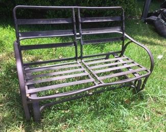 Metal glider with rugged cloth straps, awaiting your choice of cushions