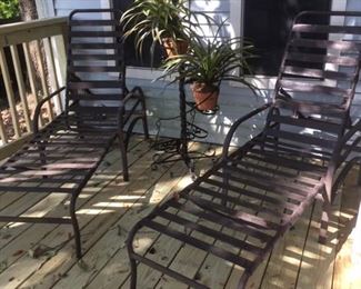 Pair of metal chaises with rugged strap supports, awaiting your choice of cushions; detail of tiered plant stand show in next photo