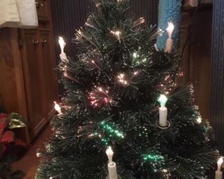 Fibre optic Christmas tree with ceramic base; the optics are in the candles and the tree, and along with star topper, the color changes from green to pink to white.