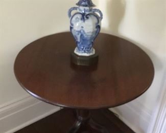 Antique small tea table with antique blue and white lamp.