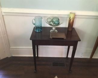 Antique side table with vintage glass
