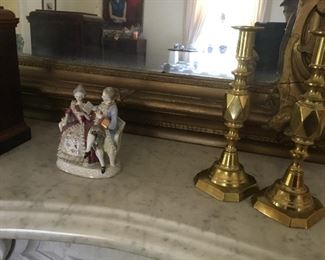 Antique push up brass candlesticks plus an antique figurine