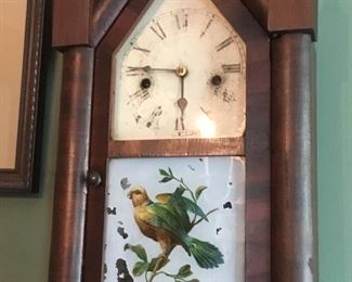 Antique clock with painted bird on glass