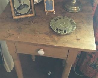 Antique table with portrait of Robert E. Lee, Virginia Metalcrafter CSA trivet and antique daguerrotype.