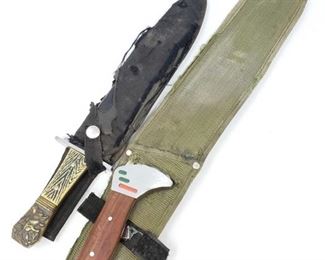 195:
9"clip point knife with decorated handle and 14" khukurri fillet and boning knife with wood handle
Two collectible knives. One 9' clip point blade with serrated spine and bevel ground edge. This one has a hawkbill ricasso with wide steel hand guard, a textured riveted yellow and black handle with gold tone bronzing on raised lion image on the butt portion of the handle. The other knife has a 14" khukurri style fillet blade with riveted wood grain handle. Both knives bear serpent and animal imagery on the cheek sections of each blade; each comes in protective sleeve.
Z2