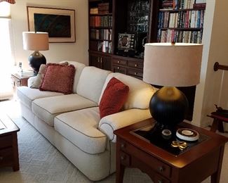 Living room view of condo with furniture in like-new condition. Lamp tables have display tops (drawer opens to place objects inside and view through glass top)