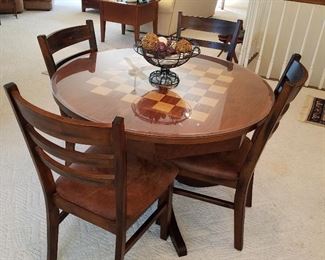 Checkerboard top table with 4 chairs (has glass over wood top)