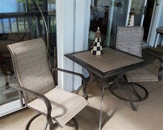 Pair of swivel chairs with tile top table