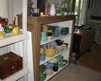 Primitive painted cabinet with pitchers and bowls