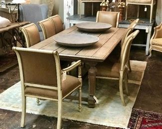 Set of eight Italian distressed painted chairs covered in leather. Paired with a rustic farm  trestle table. Pair of large Tunis bowls on the table top. 