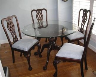 Round table with glass top and 4 Chippendale style chairs