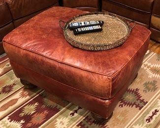 Nicely worn leather ottoman & area rug 