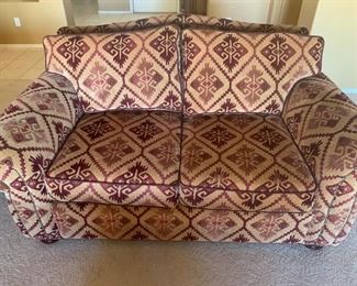Loveseat with burgundy pattern